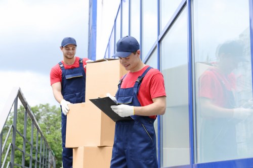Worker using safe lifting techniques during a removal