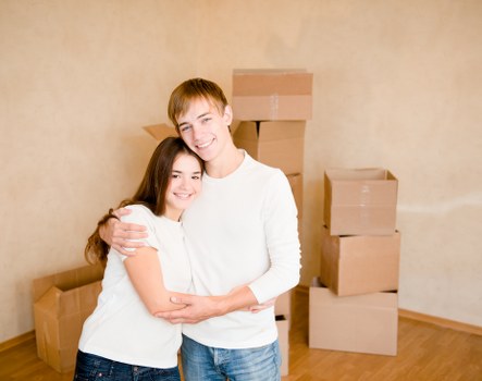 Movers carrying furniture through a Balham flat staircase