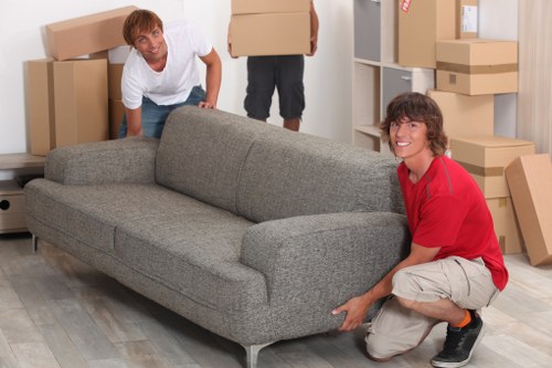 Professional movers carrying furniture in Balham